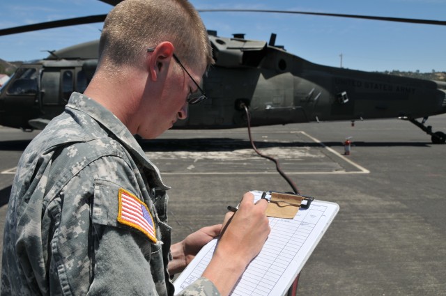 SPC Cody Miarer checks fuel info at Fort Hunter Liggett