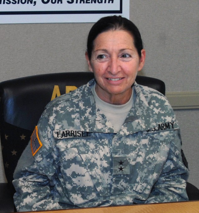 Maj. Gen. Gina S. Farrisee, outgoing commanding general of the U.S. Army Human Resources Command, sits at a conference table.
