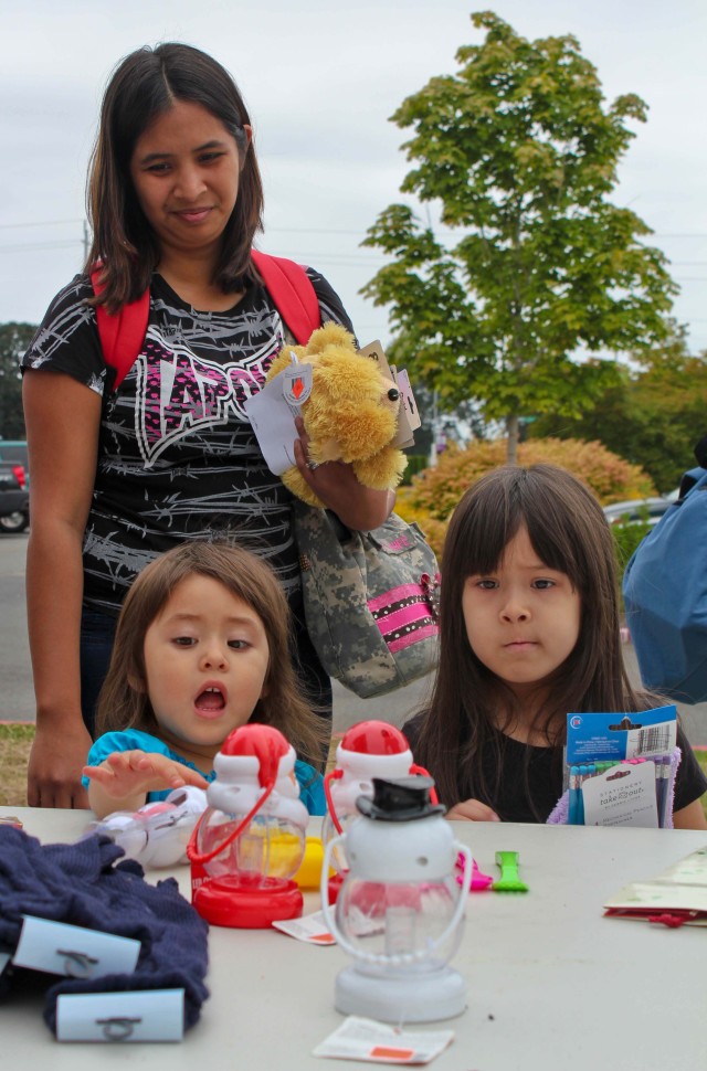 Military children pick through free supplies