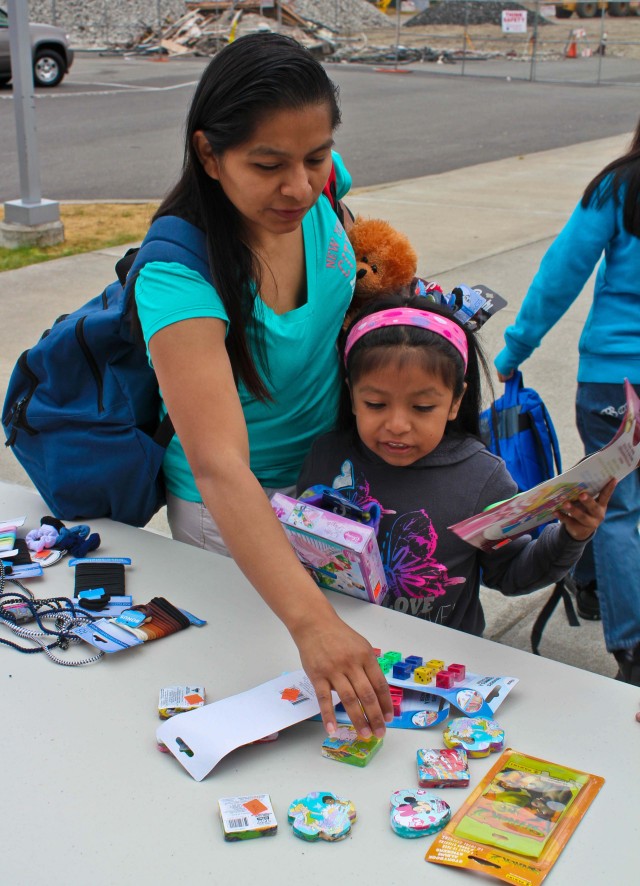 Family adds to backpack full of free supplies