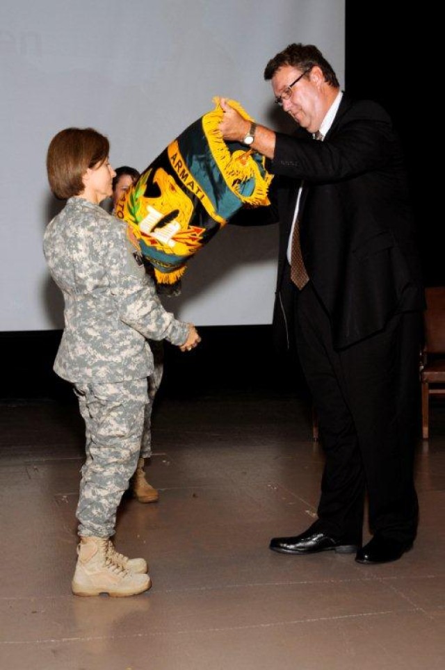 Maj. Gen. Camille M. Nichols, ACC commanding general, presents the new