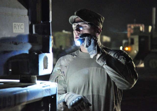 Soldiers transport cargo during night time operations