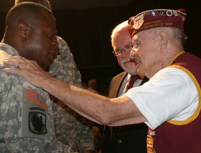 Command Sgt. Maj. Gerald Williams (left) Network Enterprise Technology Command command sergeant major congratulates retired U.S. Army Capt. Richard Cooksley after he received the Bronze Star on Tuesda