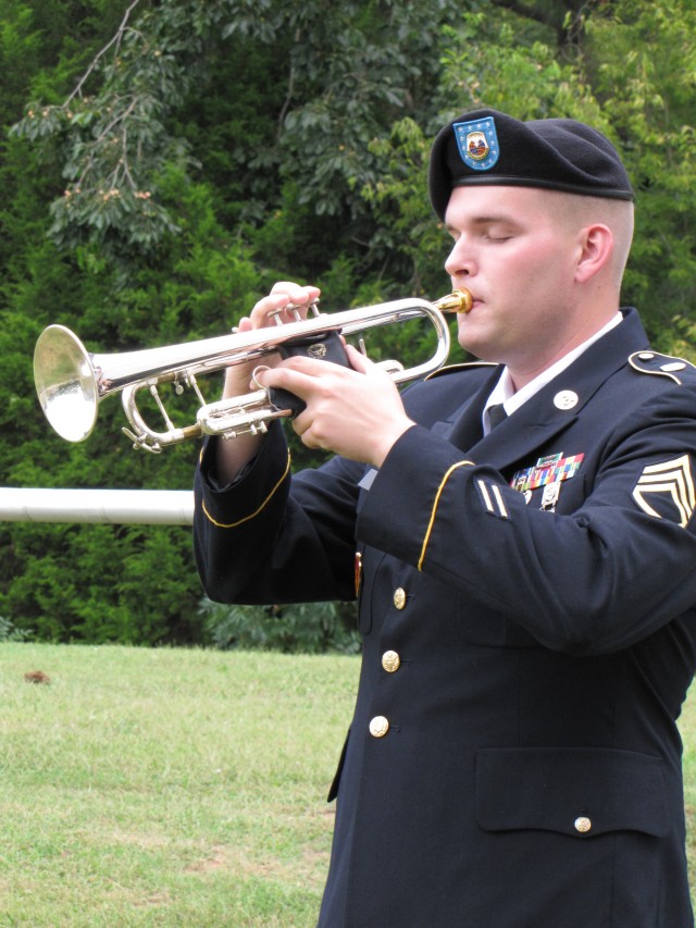 Staff Sgt. Lawrence Henry plays Taps