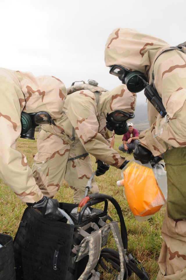 Soldiers prepare a back pack with disclosure solution