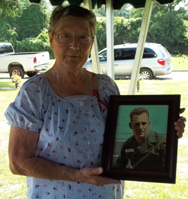 Widow holds photo of husband