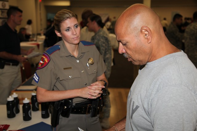 Military member meets with recruiter at career fair