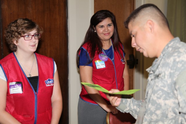 Military member meets with recruiter at career fair