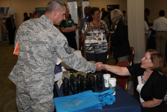 Military member meets with recruiter at career fair