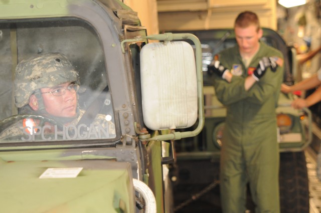 CCP loads a High Mobility Multipurpose Wheeled vehicle in a C-17
