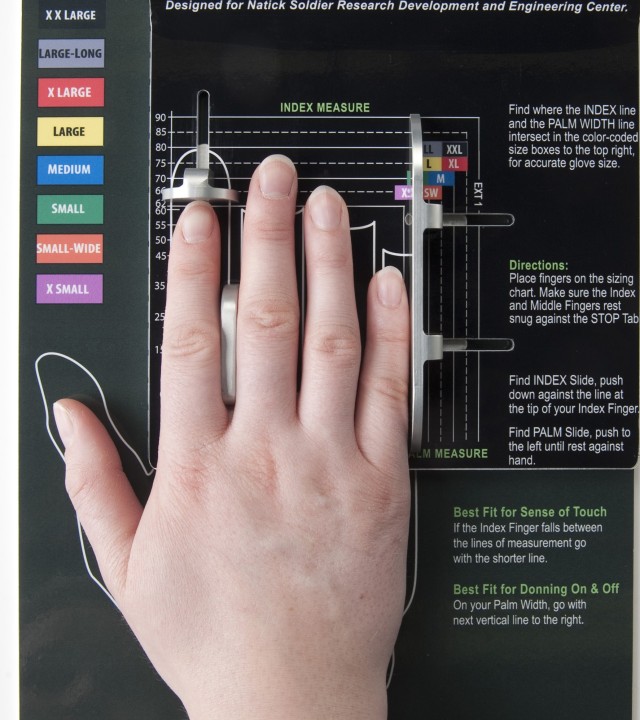 Hand being measured using hand-sizing tool