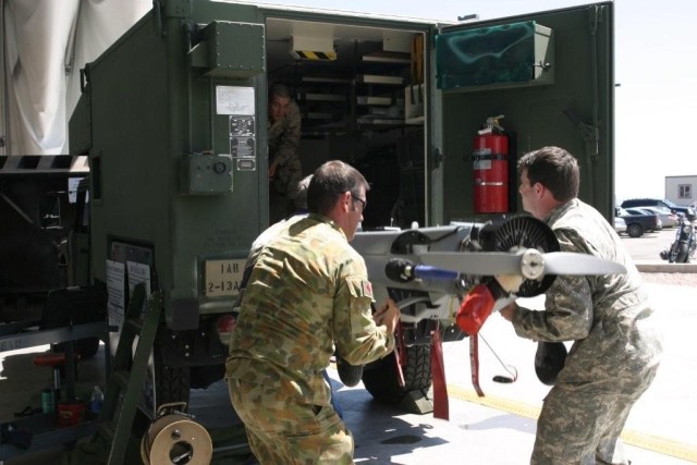 Specially trained 15E unmanned aircraft systems repairers load an unmanned aircraft system into a truck for transport. Soldiers in the 15E military occupational specialty provide maintenance support f