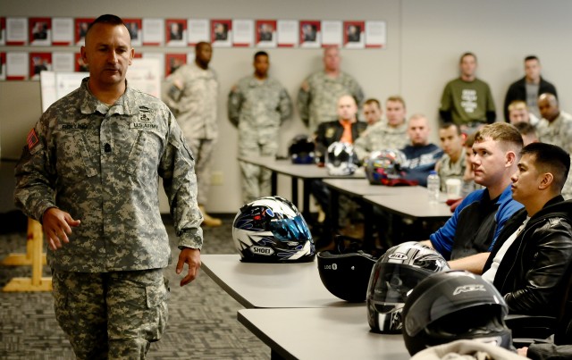 Command Sgt. Maj. Nicolas Rolling briefs motorcyclists