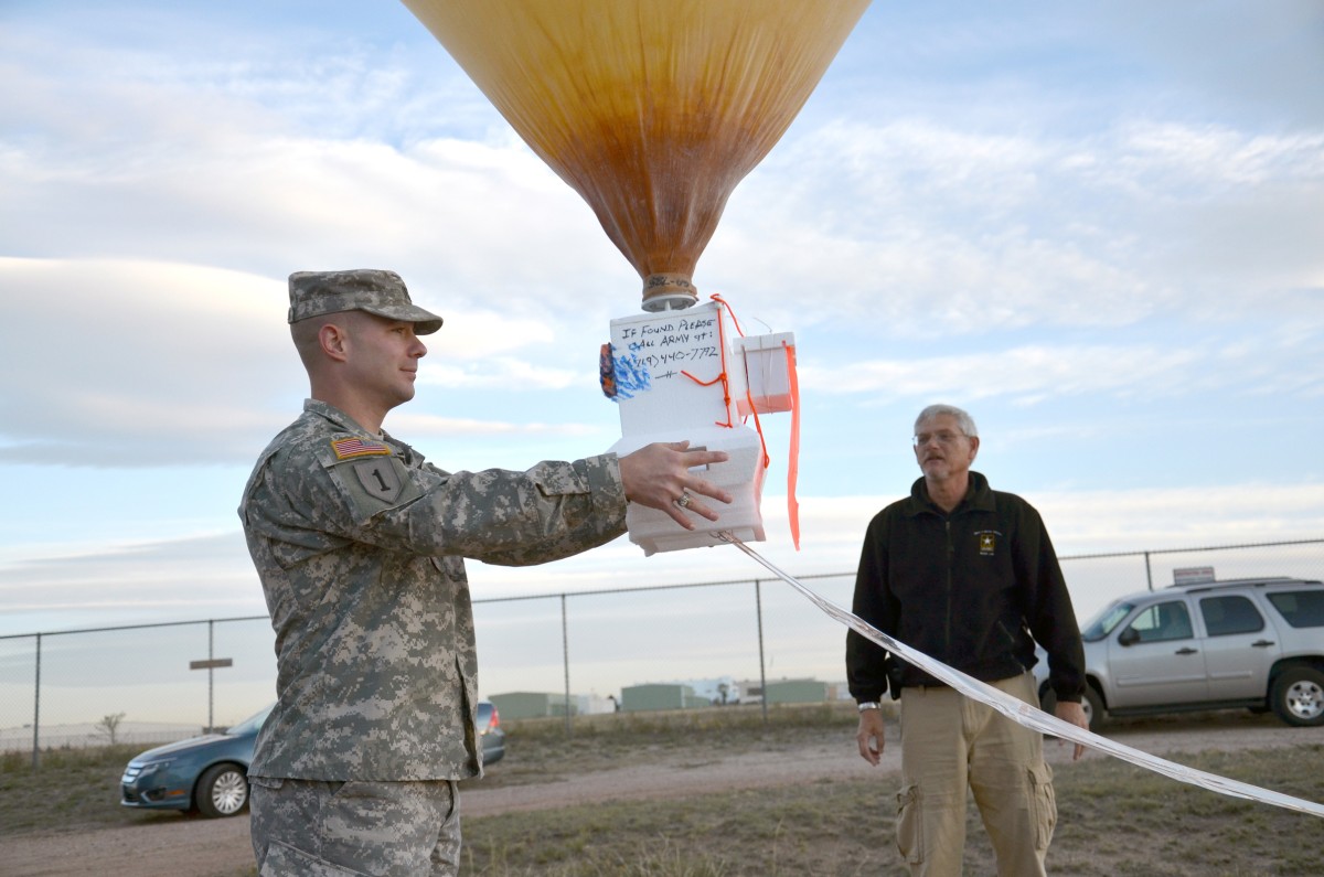 An officer launching a SkySat balloon.