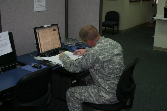 Sgt. 1st Class Joel Kramer, 2-13th Aviation Regiment, uses the computers available in the multi-use learning facility at the Education Center. This facility provides convenient study time during lunch