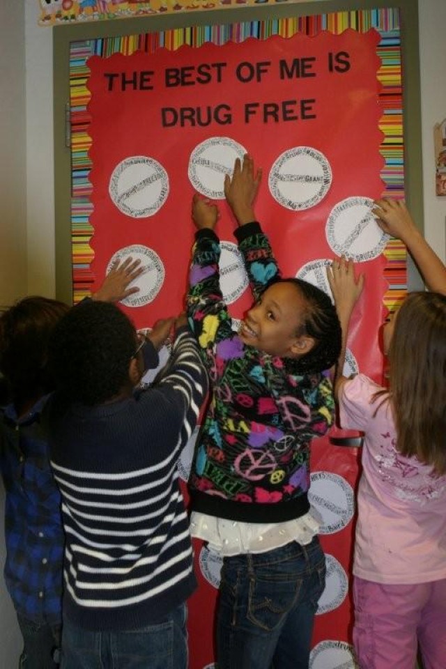 From left, Chrystian Baird, Christopher Richardson, Jalyssa Mickey and Celina Peter, all 9, decorate the door to Mrs. Johnston's classroom as part of General Myer Elementary School's Red Ribbon Week c
