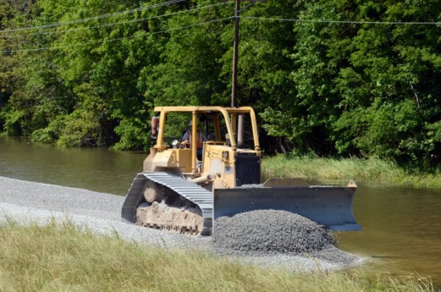 Dozer spreads gravel during typical levee construction