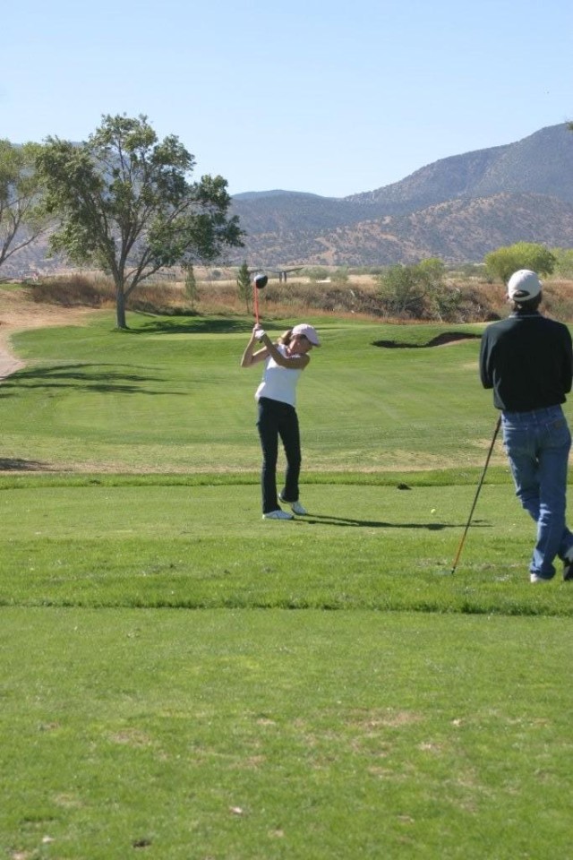 Sherry Arriaga, a local Sierra Vista resident, takes a practice swing at Hole 14. The Mountain View Golf Course is open to the public.