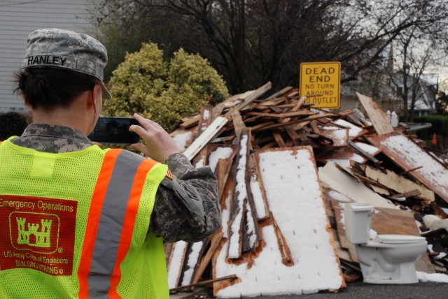 1st Lt. Erin Hanley, 554th Engineer Battalion, plots debris piles and areas of concern Nov. 8 along the coast of New Jersey