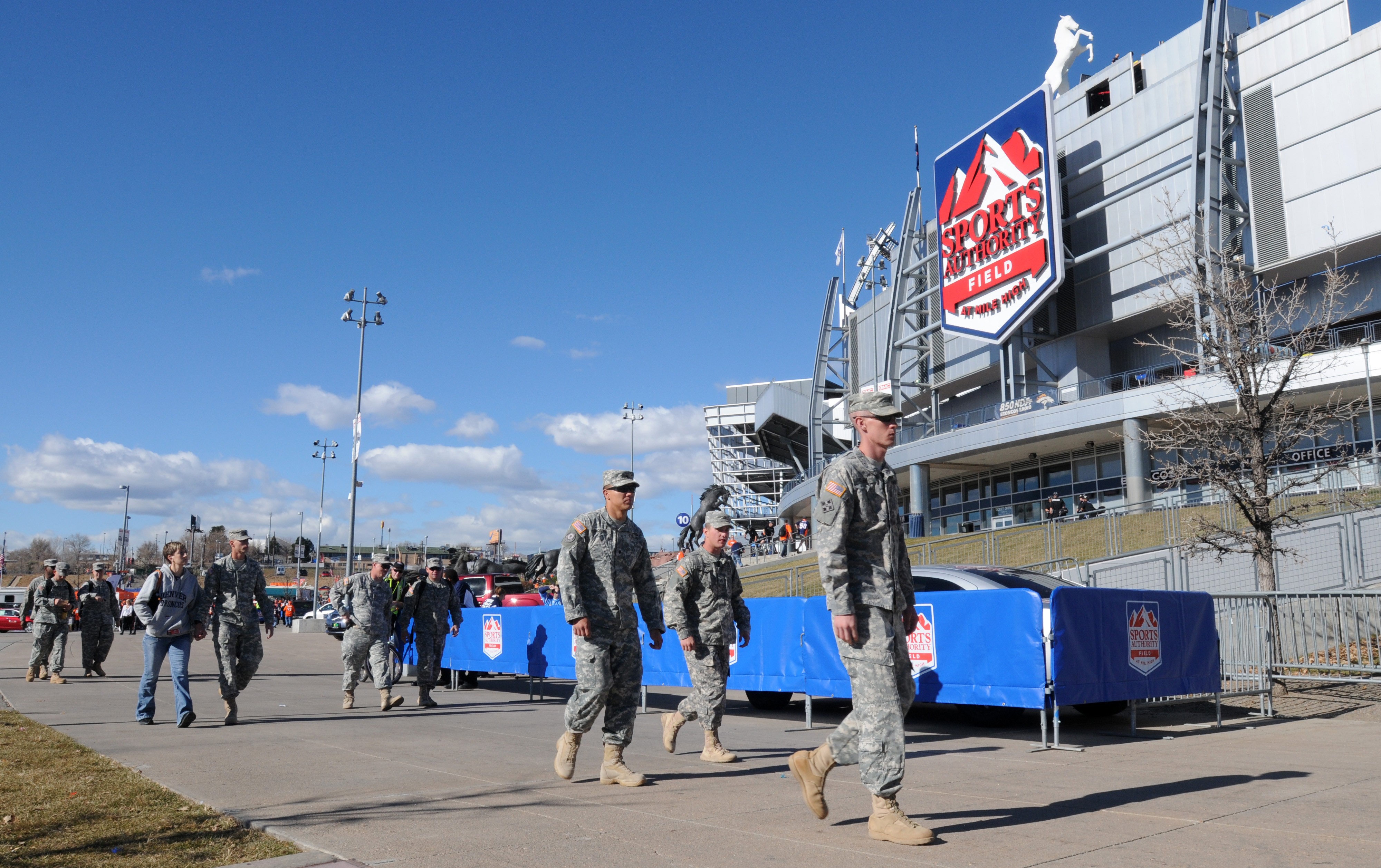 Service members stand at attention during a pre-game ceremony at