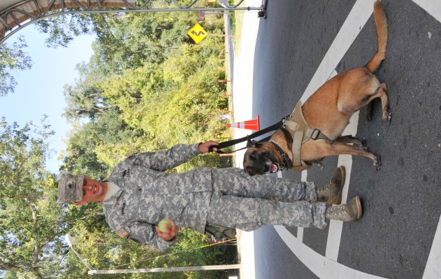 Military dog handler rewards Nikyta for a job well done