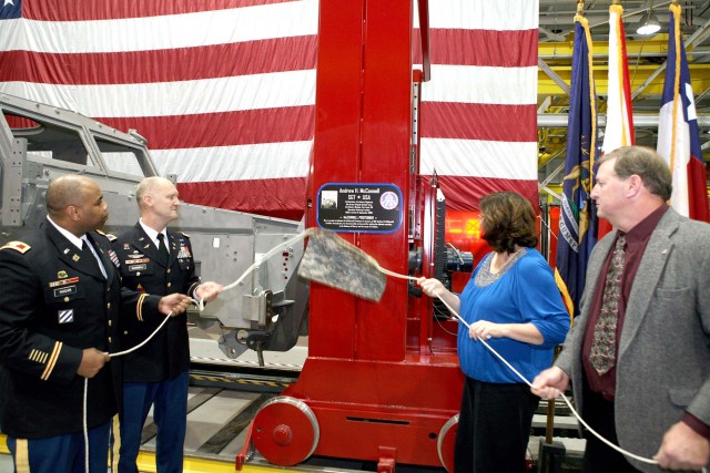 McConnell's parents along with depot commander and division chief unveil plaque