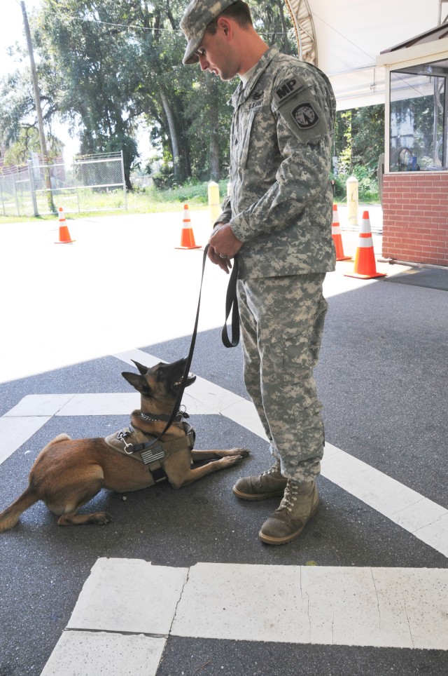 Sgt. Daniel Franklin and his dog, Nikyta rest after RAMP checks