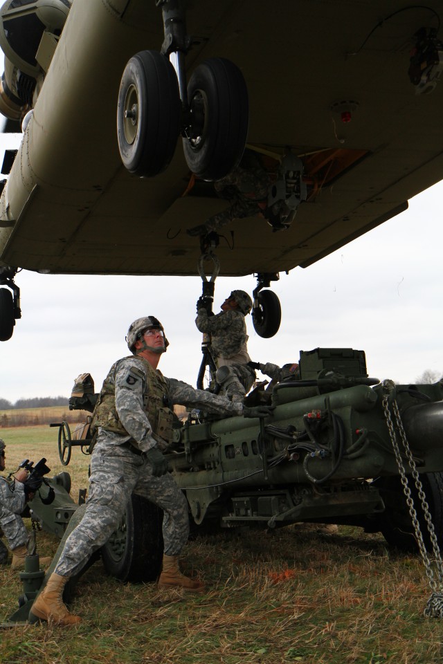 Currahees and Aviators practice sling loading M777 155mm howitzers.