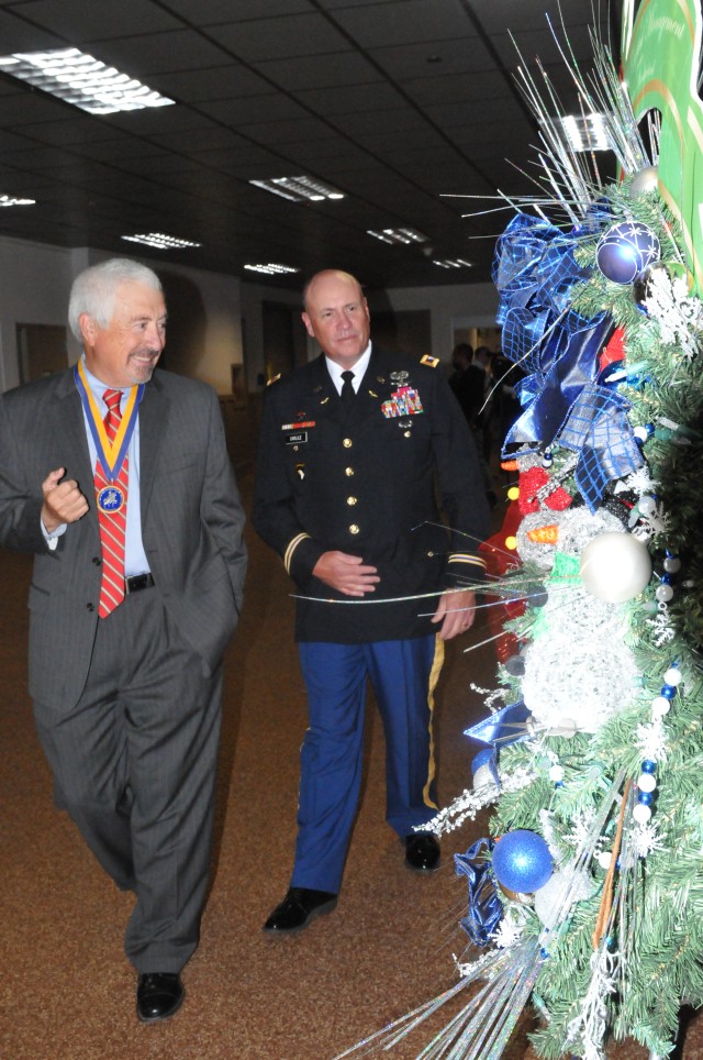 Depot Commander, Colonel Christopher B. Carlile shows former Mayor Joe Adame some of the holiday wreaths designed by the CCAD workforce