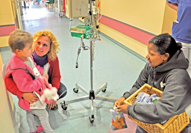 Spreading cheer: BOSS members help put smiles on young cancer patients' faces during hospital visit