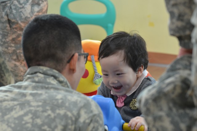 Soldier Plays with Child from Jacob's Orphanage