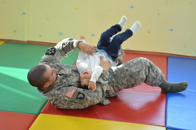 Soldier Plays with Child from Jacob's Orphanage