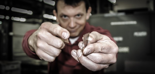 CCAD employee, John Herzer, holds out an inlet guide vane