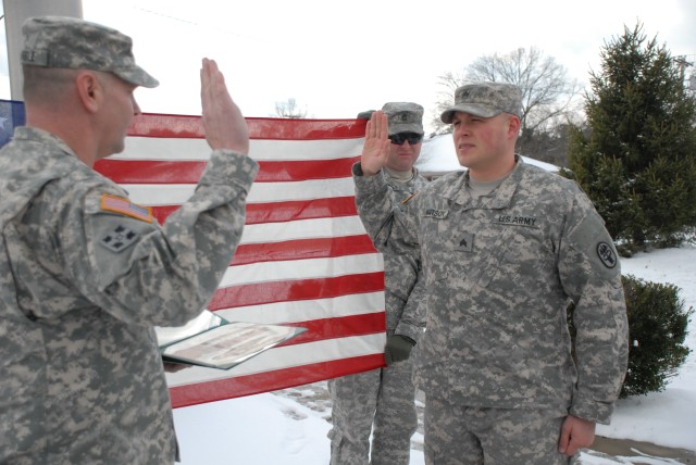 Lt. Col. Peter E. Dargle administers the reenlistment oath with SGT Christopher J. Watson II