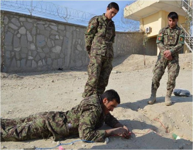 Afghan soldier clears the way