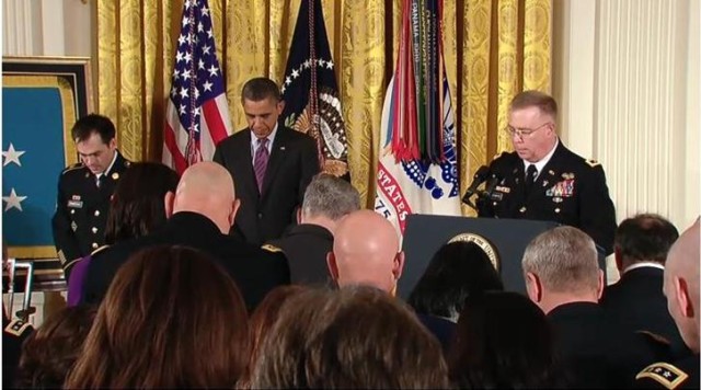 Chaplain (Major General) Donald Rutherford prays at Clinton Romesha's Medal of Honor ceremony