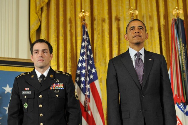 President Obama and Staff Sgt. Romesha stand at attention