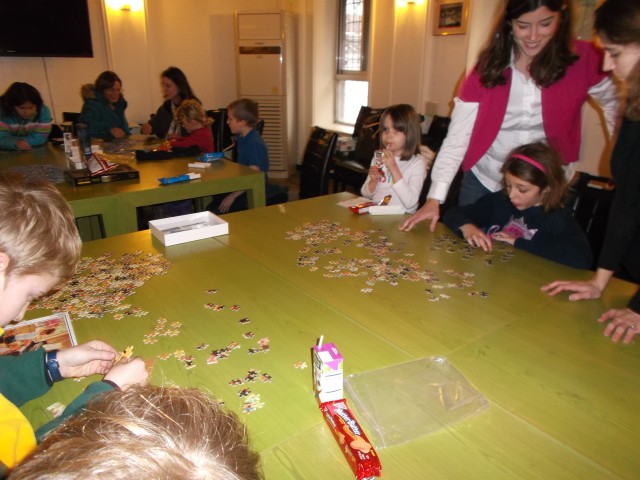Home school students build jigsaw puzzles, friendships