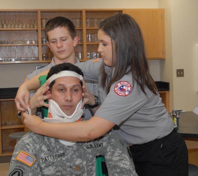 Members of the 81st Civil Affairs Battalion help teach EMT skills to high school students