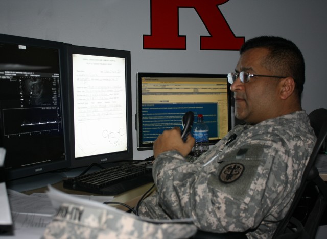 Maj. Mustafa Ali-Khan, officer in charge of Radiology here, reads an untrasound exam.