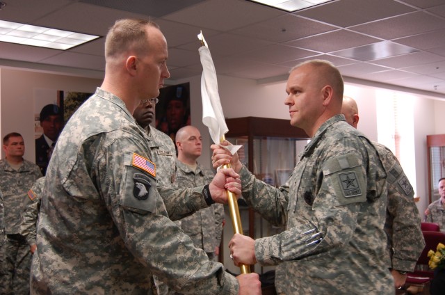 Incoming Commandant Accepts Unit Flag from Brigade Commander