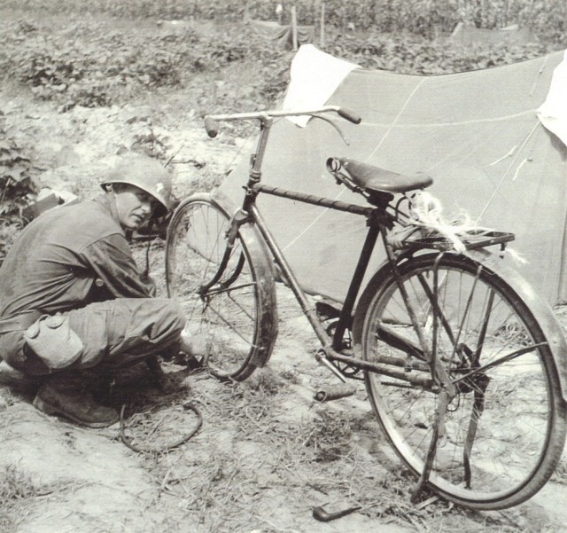Kapaun repairs his bicycle