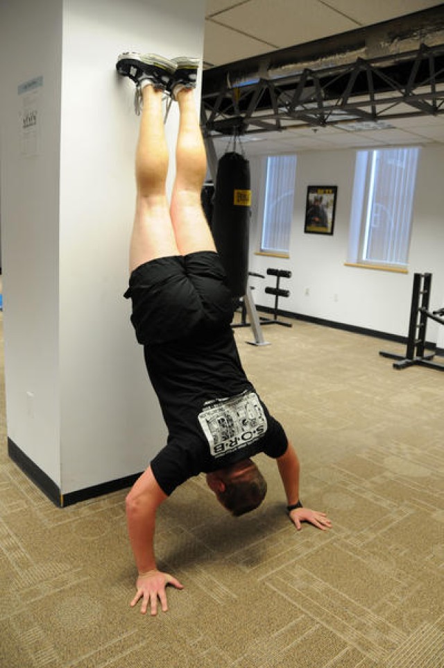 Sgt. 1st Class Kenyon Roberts does handstand pushups.