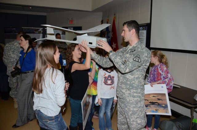 Officer presents a Raven unmanned aircraft to students during career day presentation