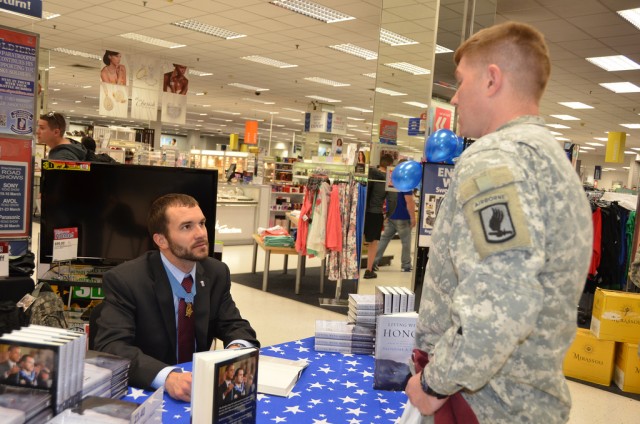 Medal of Honor recipient and former 173rd ABCT Sky Soldier Sal Giunta (from left), talks with Aly and Col. Andrew Rohling after a welcome home event for redeploying Soldiers March 19, 2013, in the Cas