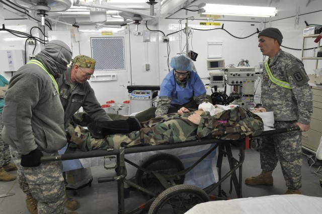 212th Combat Support Hospital Soldiers prepare a simulated casualty for surgery