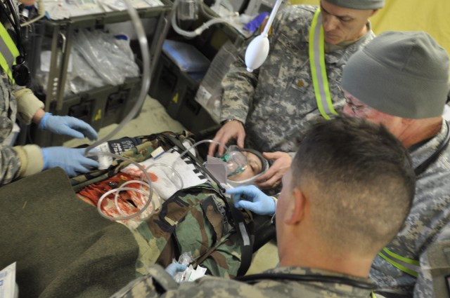 Army nurses from the 212th Combat Support Hospital evaluate a simulated casualty