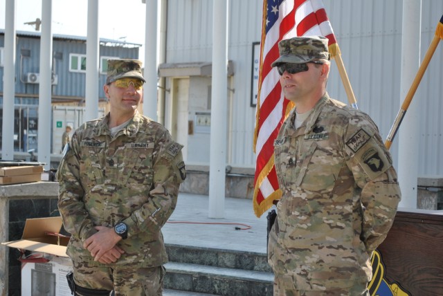 Bastogne Soldier receives Combat Action Badge from his father