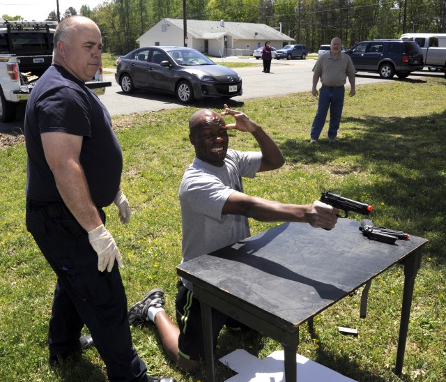 Department of the Army police training officer Lt. Ronald Henson (left) guided each security guard through the gauntlet after he sprayed them with pepper spray. After he emptied his pistol, security g