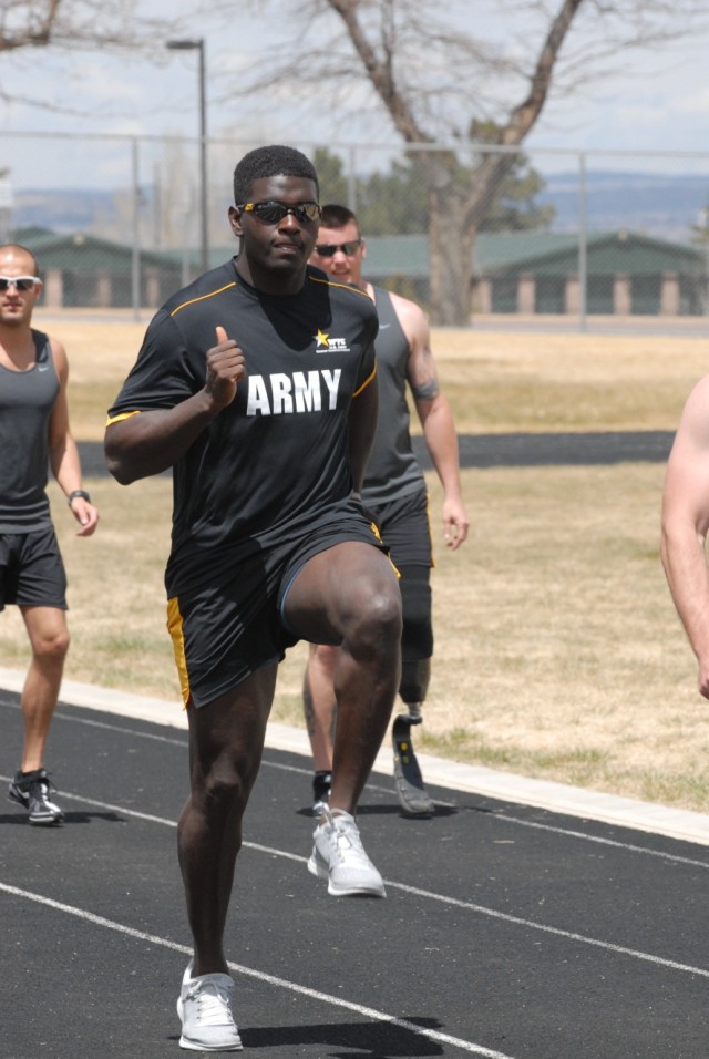 Spc. Almon Runs Alongside Team Army Competitors